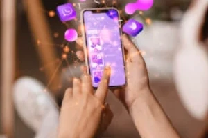 person using a phone with social media icons, managed by a digital marketing strategist in palakkad.